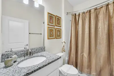 a bathroom with a sink and a shower curtain at Ev4795 - Kings Oasis in Kissimmee