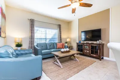 a living room with a couch and a tv at Ev4796 - Palm Bay Retreat in Kissimmee