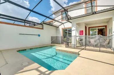 a swimming pool in the backyard of a house at Ev4804 - Starlight Retreat in Kissimmee