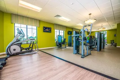 a gym with treadmills and elliptical machines at 4811Ll Amazing 5 Bedroom 4 Bathroom in Kissimmee