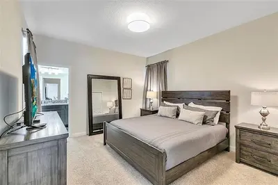 a bedroom with a bed and a television in it at Ev4815 - Regal Escape Villa in Kissimmee