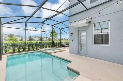 a swimming pool in a house with a patio at Ev4815 - Regal Escape Villa in Kissimmee