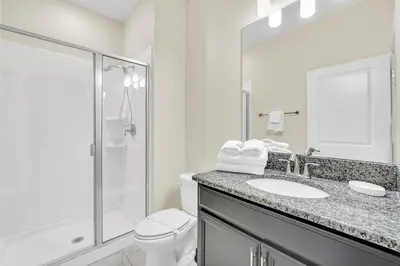 a bathroom with a toilet and a sink and a shower at Ev4876 - Charming Palms Villa in Kissimmee
