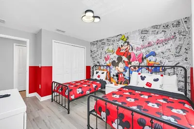 a bedroom with a bed and a wall mural at Ev4876 - Charming Palms Villa in Kissimmee