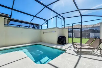 a swimming pool in a house with a glass roof at Ev4876 - Charming Palms Villa in Kissimmee