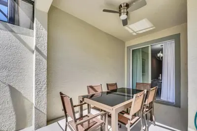 a dining room with a table and chairs at Ev4876 - Charming Palms Villa in Kissimmee