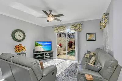 a living room with a couch and a tv at Ev4886 - Palm Haven Escape in Kissimmee