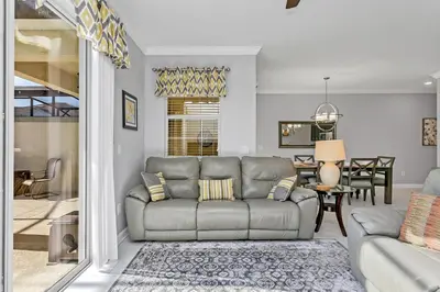 a living room with a couch and a dining room at Ev4886 - Palm Haven Escape in Kissimmee