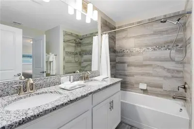 a bathroom with two sinks and a shower and a tub at Ev4887 - Golden Palms Retreat in Kissimmee