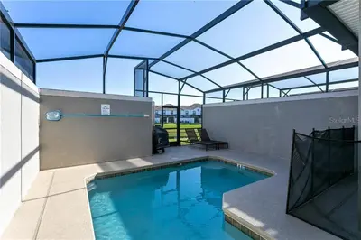 an indoor swimming pool with a glass roof at Ev4887 - Golden Palms Retreat in Kissimmee
