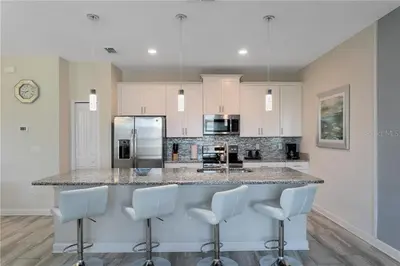 a kitchen with a large counter with white appliances at Ev4887 - Golden Palms Retreat in Kissimmee