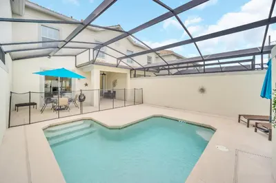 an indoor swimming pool with a patio and a house at Ev4927 - Beautiful Storey Lake in Kissimmee