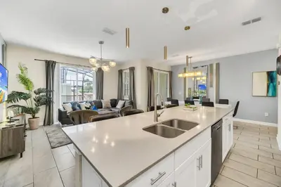 a kitchen and living room with a sink and a couch at Ev4987 - Raceway Retreat in Kissimmee
