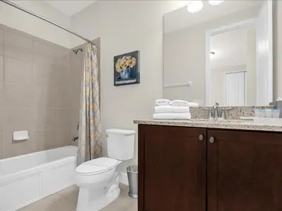 a bathroom with a toilet and a sink and a mirror at Ev7501 - Encore in Orlando