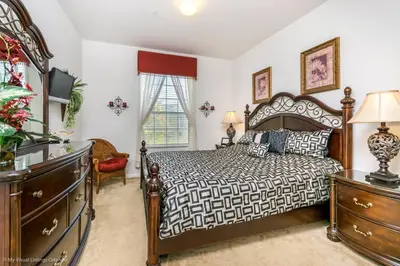 a bedroom with a bed and a dresser at Ev76604 - Windsor Condo in Orlando