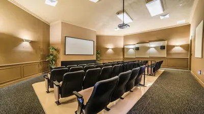 a conference room with black chairs and a screen at 7664Unit403 in Orlando