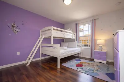 a childs bedroom with a bunk bed and purple walls at Ev89270 - Paradise Manor in Kissimmee