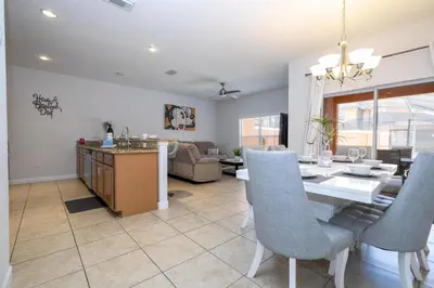 a dining room and living room with a table and chairs at Ev89270 - Paradise Manor in Kissimmee