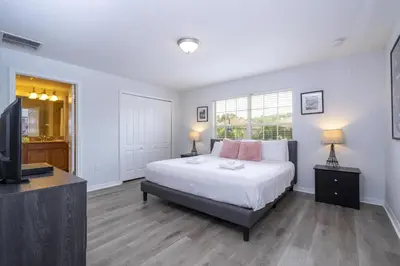 a bedroom with a bed and a flat screen tv at Ev89270 - Paradise Manor in Kissimmee