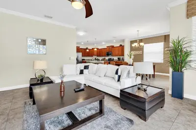 a living room with a white couch and a table at Ev8927 - Paradise Dream Retreat in Kissimmee
