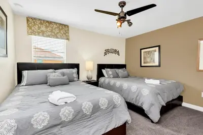a bedroom with two beds and a ceiling fan at Ev8927 - Paradise Dream Retreat in Kissimmee