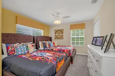 a bedroom with two beds and a ceiling fan at Ev8950 - Paradise Oasis Villa in Kissimmee