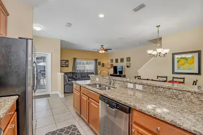 a kitchen with a sink and a refrigerator at Ev8950 - Paradise Oasis Villa in Kissimmee