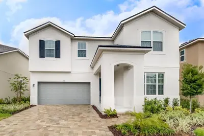 a white house with a garage at Ev9071- Solara Cove in Orlando