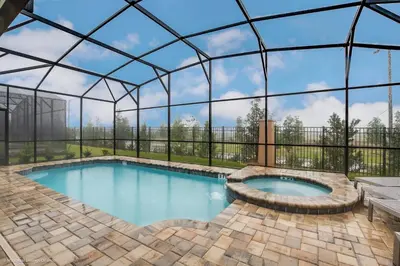 a swimming pool in a glass igloo with a patio at Ev9071- Solara Cove in Orlando