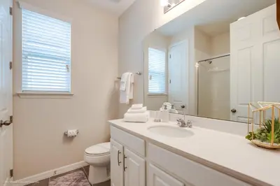 a white bathroom with a sink and a toilet at Ev9071- Solara Cove in Orlando