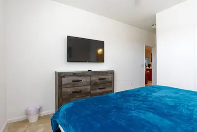 a bedroom with a bed and a flat screen tv at BellaVida 8 bed Theme Rooms in Kissimmee