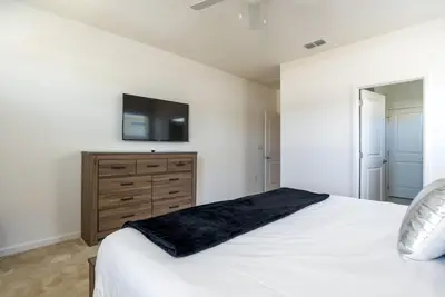 a bedroom with a bed and a tv on a wall at BellaVida 8 bed Theme Rooms in Kissimmee