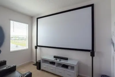 a room with a large screen on the wall at BellaVida 8 bed Theme Rooms in Kissimmee