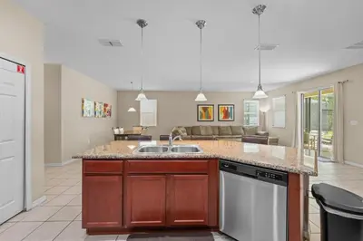 a kitchen with a sink and a dishwasher at 4 Bed Close to Disney Private Pool in Kissimmee