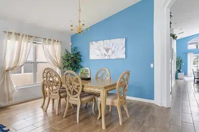 a dining room with a wooden table and chairs at Casa Térrea 4Q c/ Piscina e Game Room in Kissimmee
