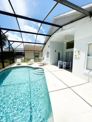 a swimming pool in front of a house at Indian Creek 4bd Pool in Orlando