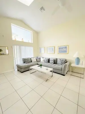 a living room with a couch and a table at Indian Creek 4bd Pool in Orlando