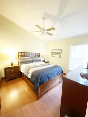 a bedroom with a bed and a ceiling fan at Indian Creek 4bd Pool in Orlando