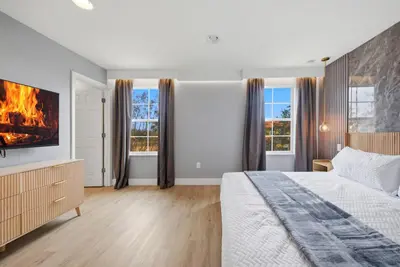 a bedroom with a bed and a fire in the fireplace at NEW Cozy 2 Bedrooms2Baths At Encantada in Kissimmee