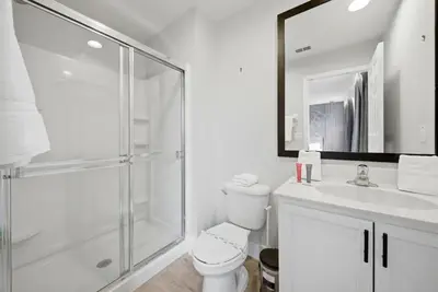a white bathroom with a shower and a toilet at NEW Cozy 2 Bedrooms2Baths At Encantada in Kissimmee