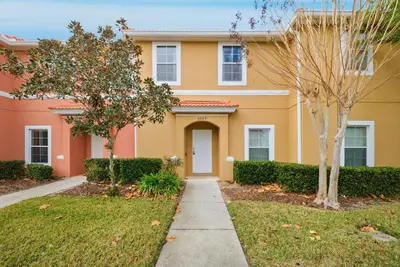 a house with a sidewalk in front of a yard at NEW Cozy 2 Bedrooms2Baths At Encantada in Kissimmee