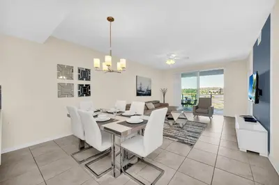 a dining room and living room with a table and chairs at Ev4721C304 - Sunset Nest in Kissimmee