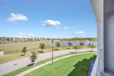 a view from the balcony of a building with a street and a lake at Ev4721C304 - Sunset Nest in Kissimmee