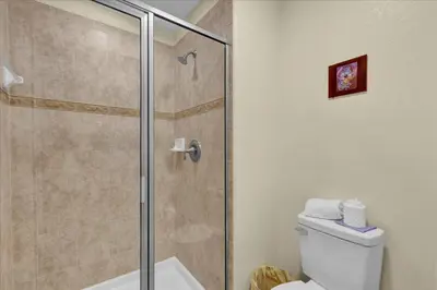 a bathroom with a shower and a toilet at 8952 Private pool 4bd townhome in Kissimmee