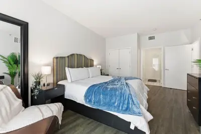 a bedroom with a large bed and a mirror at Orlando Getaway with Pool View Balcony in Orlando