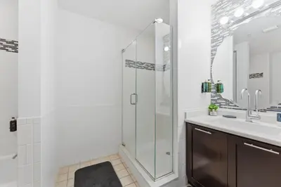 a bathroom with a glass shower and a sink at Orlando Getaway with Pool View Balcony in Orlando