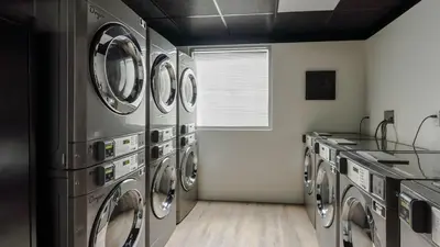a laundry room with a bunch of washing machines at Orlando Getaway with Pool View Balcony in Orlando