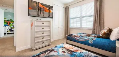a bedroom with a bed and a dresser at Ultimate Mansion-9Bed-PoolSpaGame in Orlando