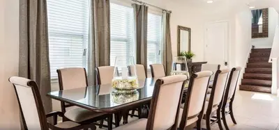 a dining room with a glass table and chairs at Ultimate Mansion-9Bed-PoolSpaGame in Orlando