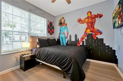 a bedroom with a superhero mural on the wall at Windsor Hills Marvel Themed Home with Private Pool in Orlando